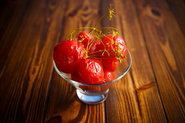 ripe red marinated tomatoes in a glass bowl