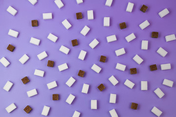 Fototapeta na wymiar Brown and white sugar cubes pattern on violet background.