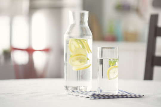 Water Bottel And Glass Of Water With Lemon In Kitchen