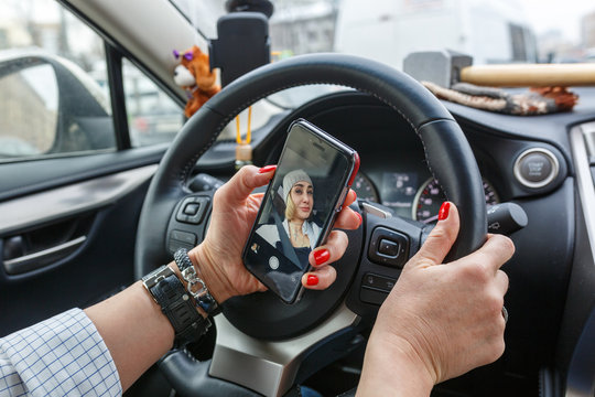 Women is making a selfie while driving