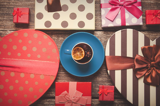 Cup of tea with lemon and holiday boxes