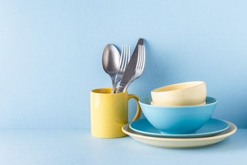 Crockery and cutlery on a blue pastel background