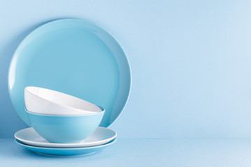 Crockery and cutlery on a blue pastel background