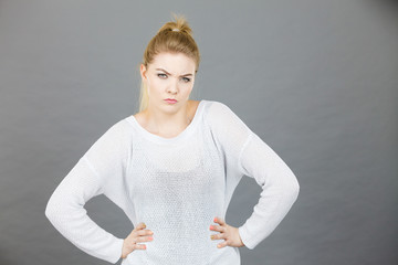 Confused young blonde woman looking suspicious