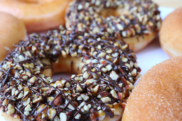 Closed up Delicious Doughnut Topped with Chocolate and Chopped Almond, Selective Focus and Blurred Background 