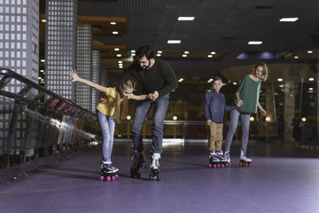 parents and kids skating on roller rink together