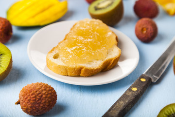 Jam of tropical fruits on bread