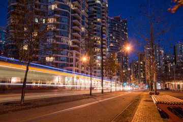 Night View of a Deserted Bicycle Lane with Light Trail Left by a Tram Passing by in Downtown Toronto