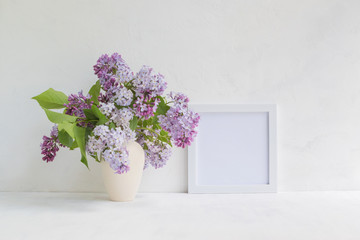 Mockup with a white frame and lilac branches