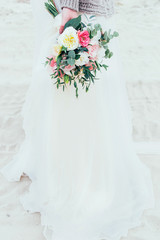 wedding bouquet in the hands of the bride