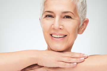 Portrait of beautiful senior woman in front of white background.