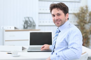 Fototapeta premium closeup.handsome businessman sitting in this Desk