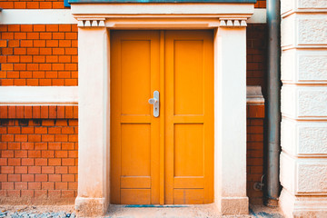 old and brown colored door on brick building