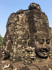Angkor Wat in Siem Reap, Cambodia. Stone faces carved in the ancient ruins of Bayon Khmer Temple
