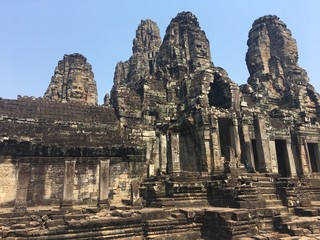 Naklejka premium Angkor Wat in Siem Reap, Cambodia. Stone faces carved in the ancient ruins of Bayon Khmer Temple