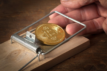fingers are trapped in a bitcoin trap