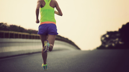 Fototapeta na wymiar young fitness asian woman runner running on city road