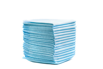 pile of toilet diapers for pets isolated on white. home absorbing towels for animals © dark_blade