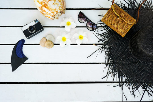 Minimal Styled Flat Lay Isolated On White Wood Background. Feminine Desk Top View With Summer Accessories: Hat, Sunglasses, Vintage Photo Camera, Handbag, Shell, Anchor, Boat, Stones, Fish