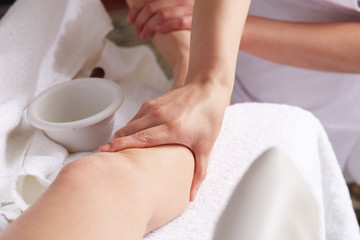 Female Enjoying Relaxing legs Massage In Cosmetology Spa Center