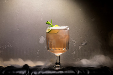 dark and stormy rum cocktail with Lime against background of smoke