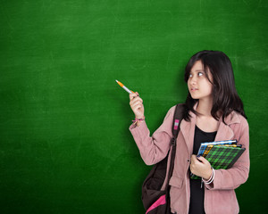 School girl presentation gesture over green chalkboard