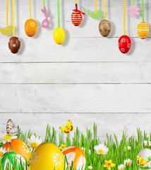 Idyllic spring meadow with Easter eggs and butterflies