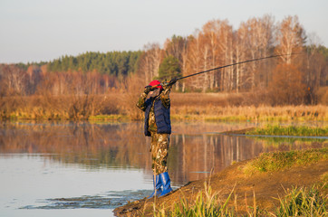 woman catches a fish on spinning