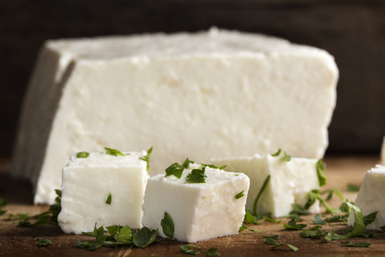 Close up of pieces of cheese with parsley leaves