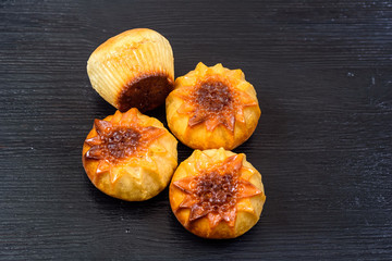 Delicious cupcake on a dark wooden background.

