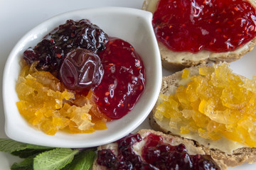 Close up of breakfast with sweet of raspberries, kumquats and blackberries..
