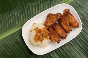 Sticky Rice and Fried chicken in plate on banana leaf