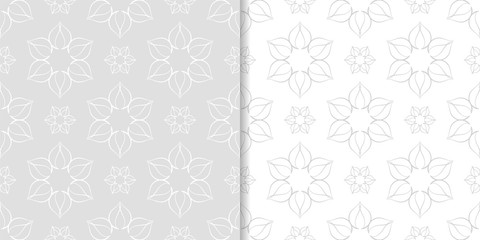 Light gray floral ornaments. Set of seamless patterns