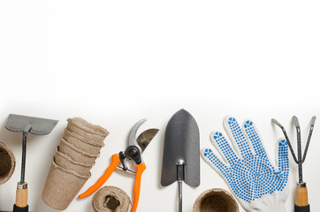 Garden tools and gloves on a white background. Space for text