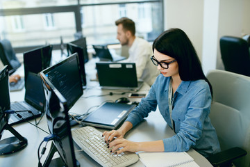 Young Woman Working And Programming On Computer In Office.