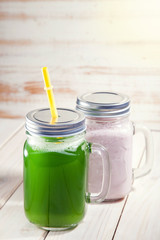 Green healthy smoothie in glass jar on rustik wood