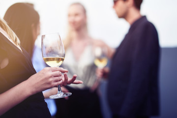 Close up of a wineglass in hands of a nice young woman