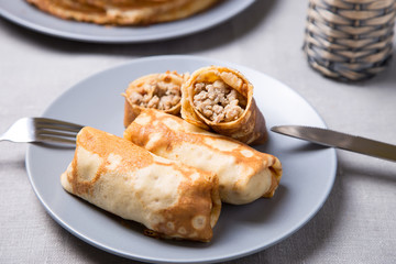 Traditional Russian pancakes with meat. Shrovetide. Maslenitsa week. Selective focus, close-up.