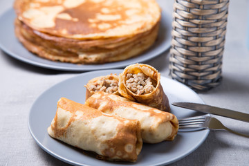 Traditional Russian pancakes with meat. Shrovetide. Maslenitsa week. Selective focus, close-up.