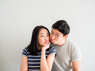Funny lovely couple trying to kiss each other. Concept of comedy love.