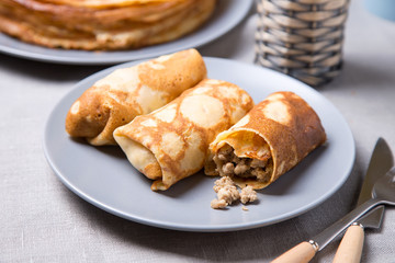 Traditional Russian pancakes with meat. Shrovetide. Maslenitsa week. Selective focus, close-up.