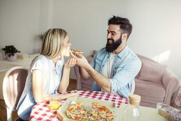 Couple eating pizza