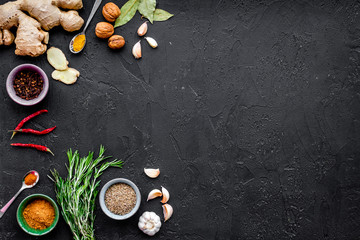 Gastronomy, culinary. Secrets of tasty dishes. Seasoning and spices. Rosemary, ginger, chili pepper on black background top view copy space