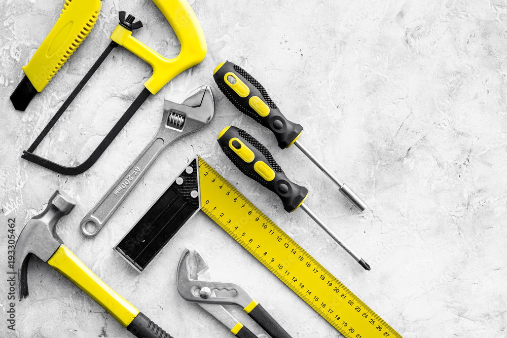 Wall mural Various repair tools. Must-have for men. Equipment for building. Repair tool kit. Grey background top view pattern copy space