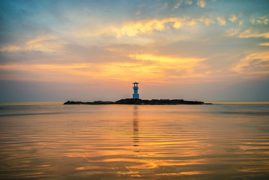 Seascape at sunset. Lighthouse on the coast © martinhosmat083