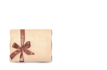 Gold box with gifts and brown bow isolated on white background