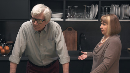 Senior couple quarreling in the kitchen interior