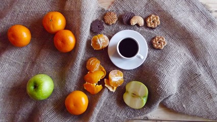 Fragrant tea and fruit on a background of burlap.