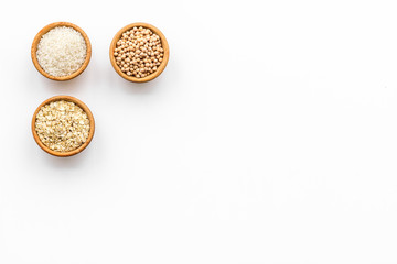 Healthy breakfast. Various cereals in bowls on white background top view copy space