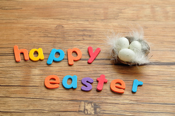 The words happy easter displayed with a nest with eggs